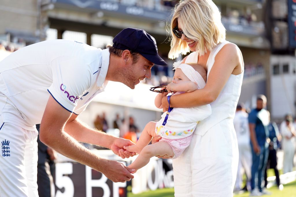 Stuart broad on cricket pitch with baby and mollie king