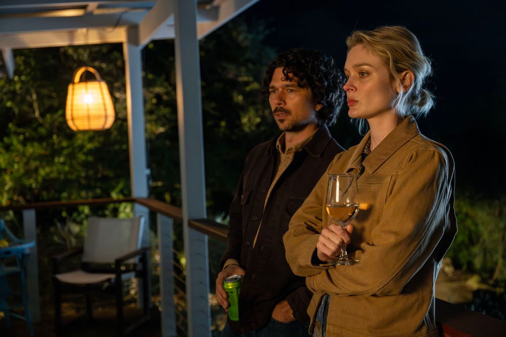 man and woman standing on porch at night 