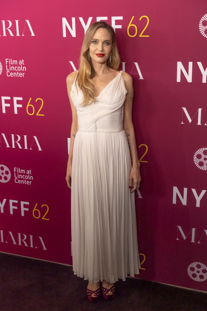 Angelina Jolie dazzled in an elegant white dress with a pleated skirt, paired with peep-toe heels