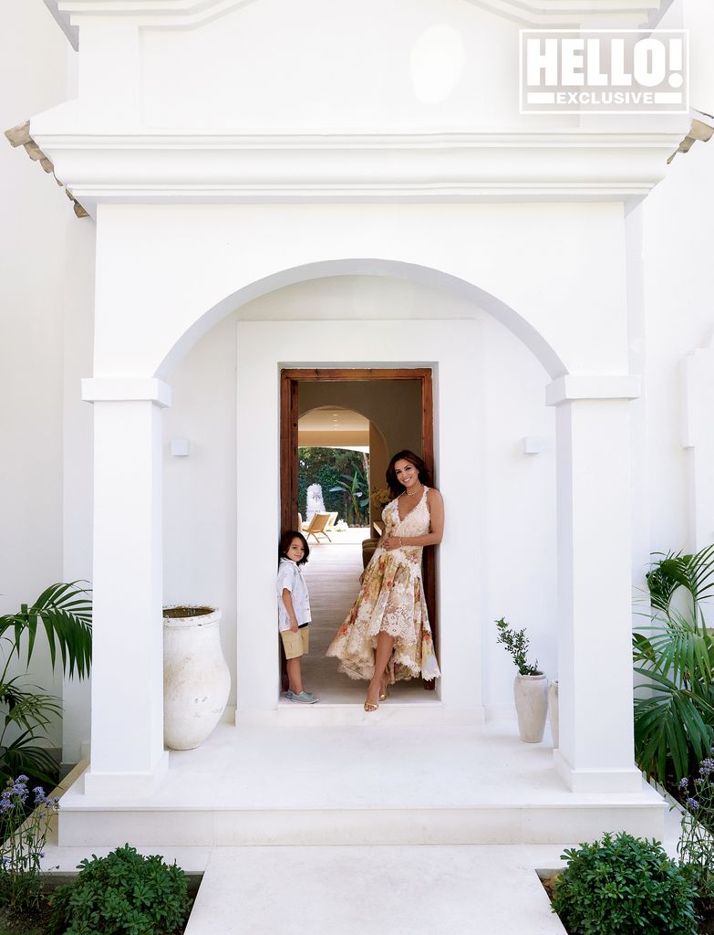 Eva Longoria and son Santiago leaning against white doorway of Marbella home