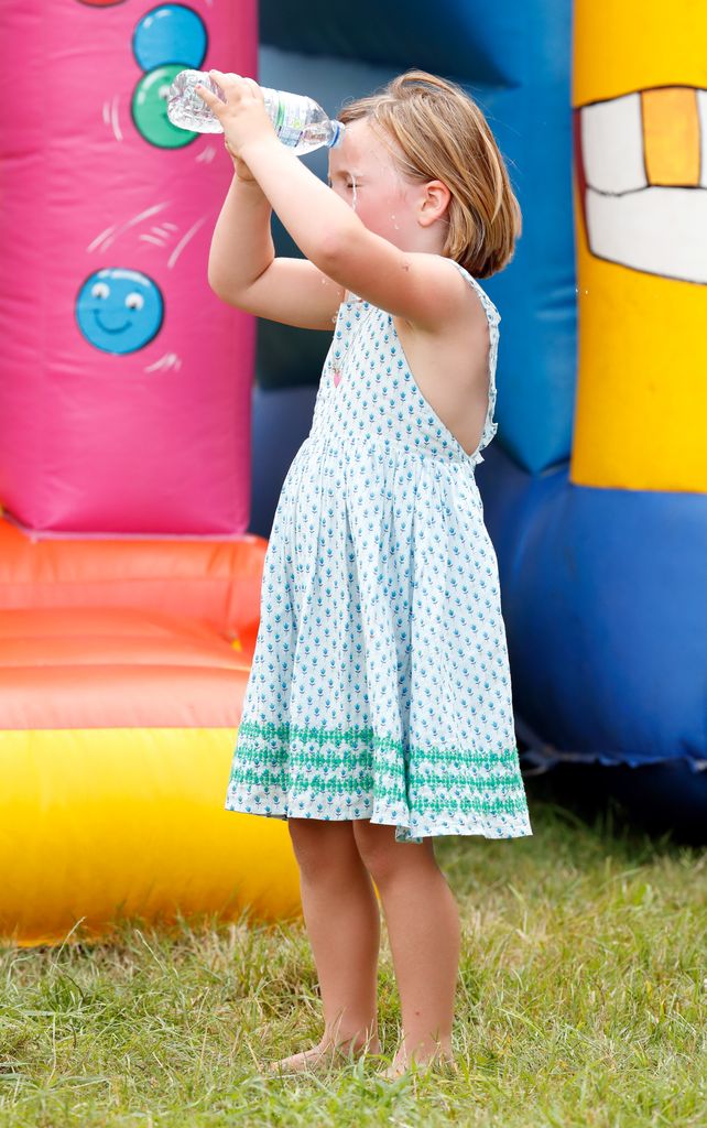 Mia Tindall pours a bottle of water over her head