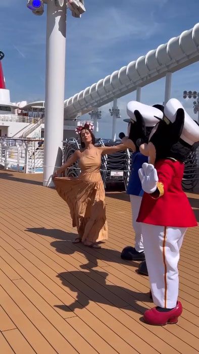 Janette dancing on deck with Disney characters