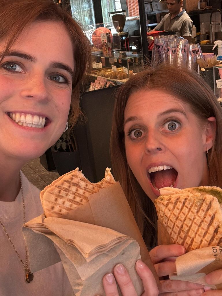 eugenie and beatrice holding up Joe & the Juice sandwich in selfie