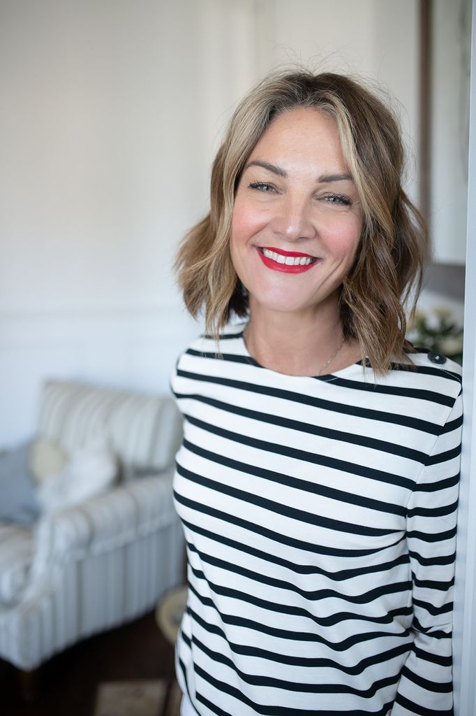 woman posing for a selfie in a striped top