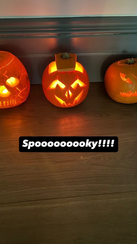 three pumpkins lined up against wall