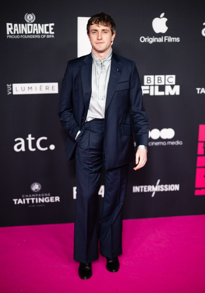 Paul Mescal on pink carpet in suit