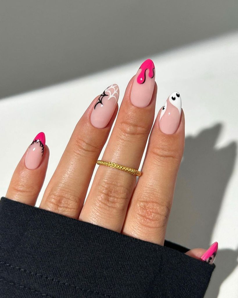 Halloween nail art with pink accents 