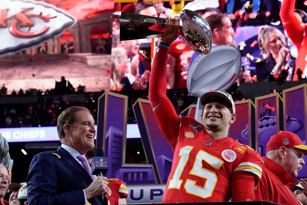 Kansas City Chiefs' quarterback #15 Patrick Mahomes celebrates with the trophy after the Chiefs won Super Bowl LVIII against the San Francisco 49ers at Allegiant Stadium in Las Vegas, Nevada, February 11, 2024.
