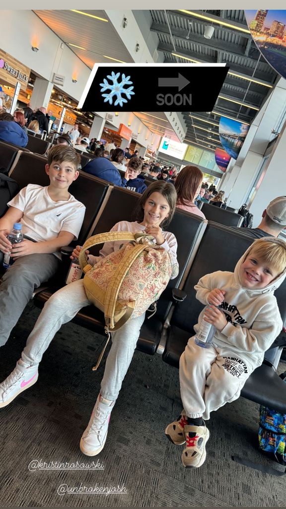 Christina Hall's son Brayden (L), a family friend,, and son Hudson (right) sit in an airport lounge