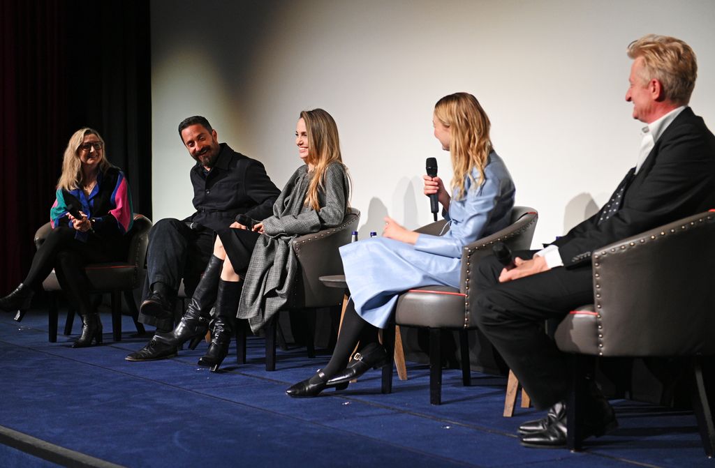 four people talking on stage