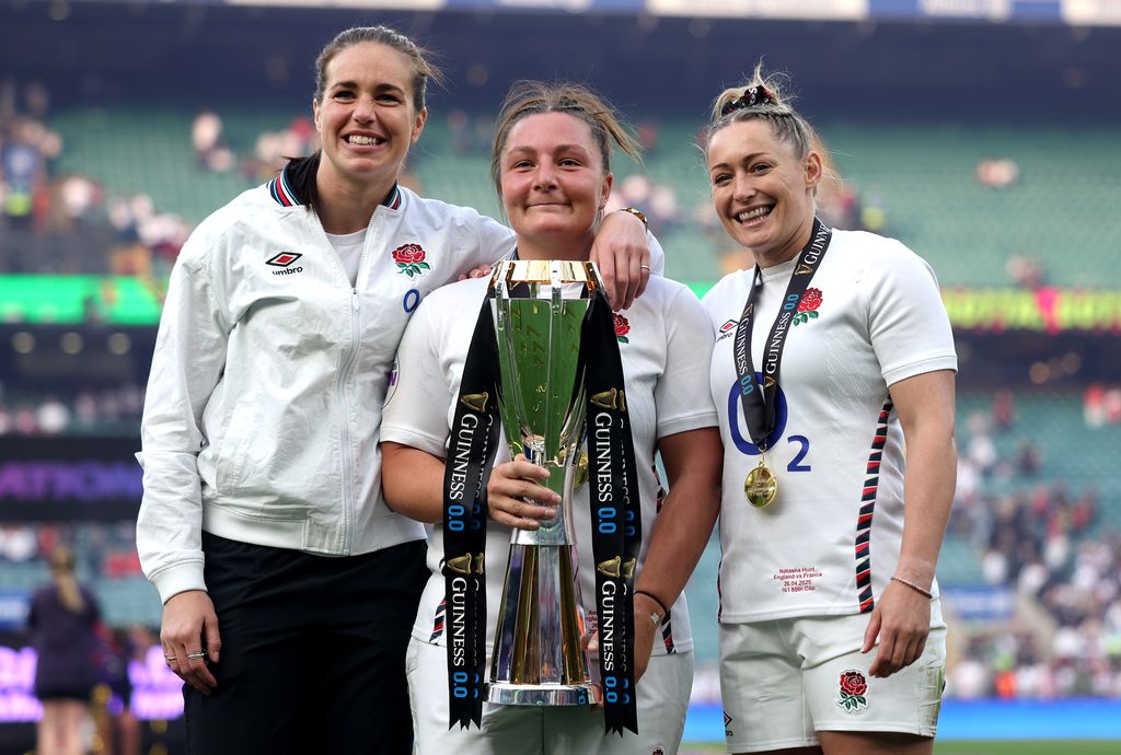Emily Scarratt of England poses for a photograph with teammates Amy Cokayne and Natasha Hunt with the Guinness Women's Six Nations Trophy