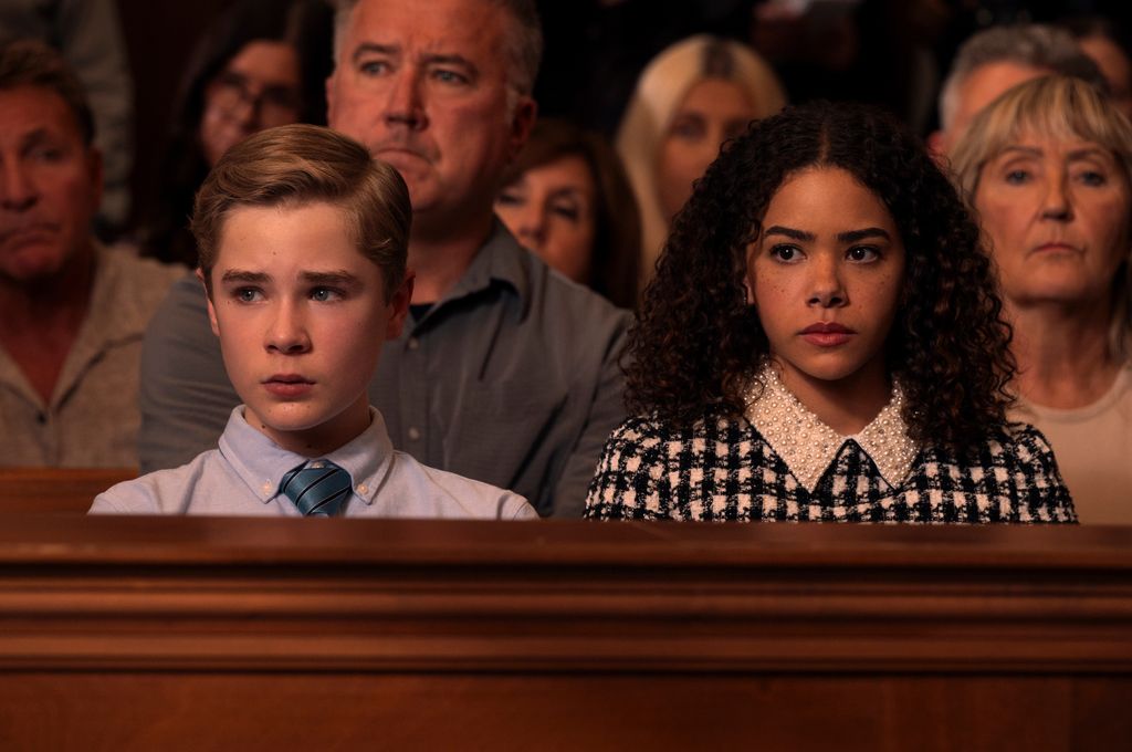 Young boy and girl looking nervous sitting in court stands