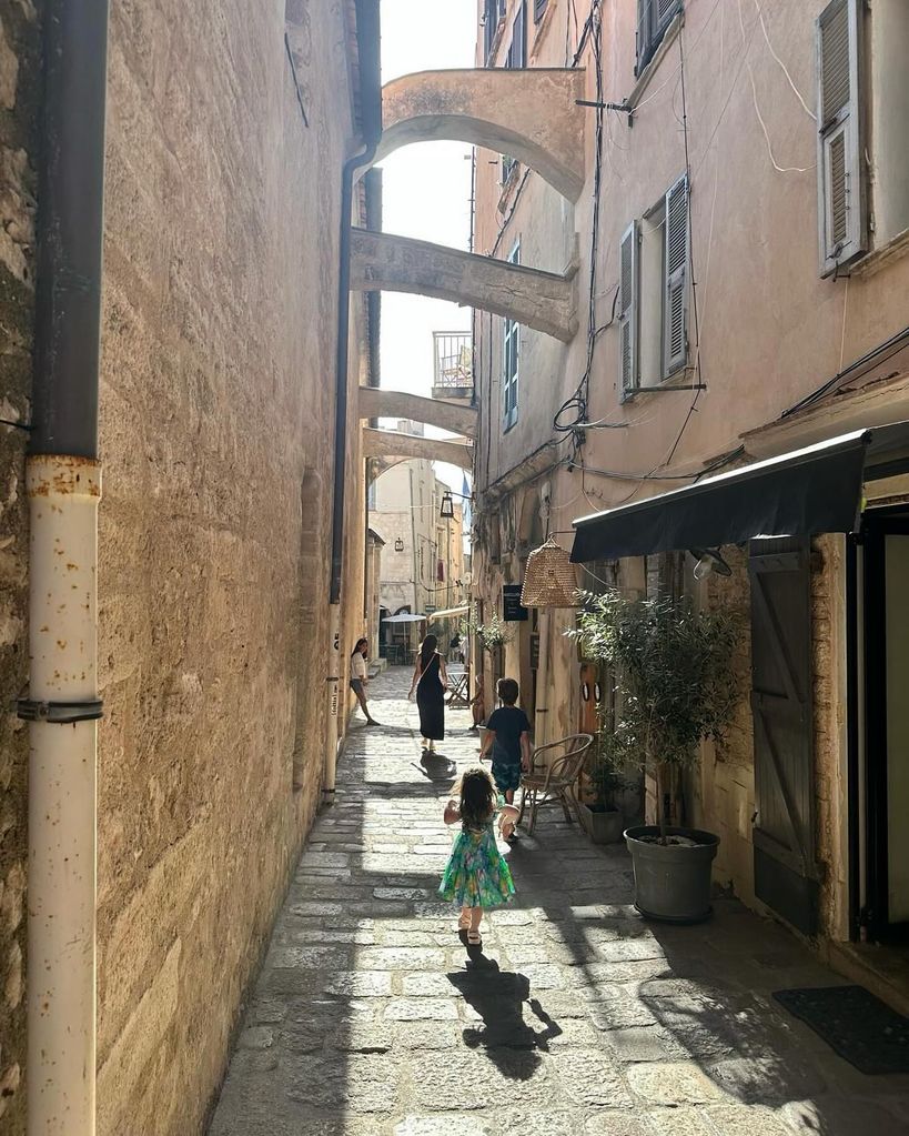 family strolling down cobbled path