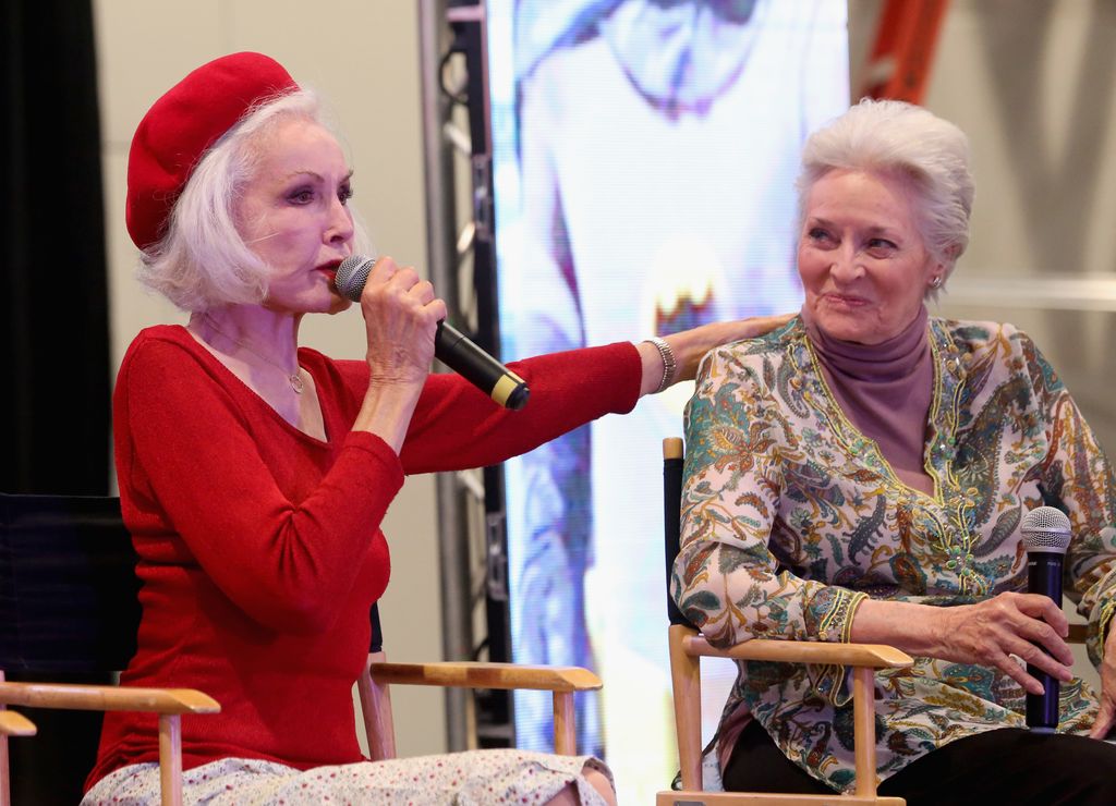 Actresses Julie Newmar (L) and Lee Meriwether speak to an attendee during the "Celebrate! Batman '66 Special Panel" at the Amazing Las Vegas Comic Con at the Las Vegas Convention Center on June 24, 2017 in Las Vegas, Nevada.