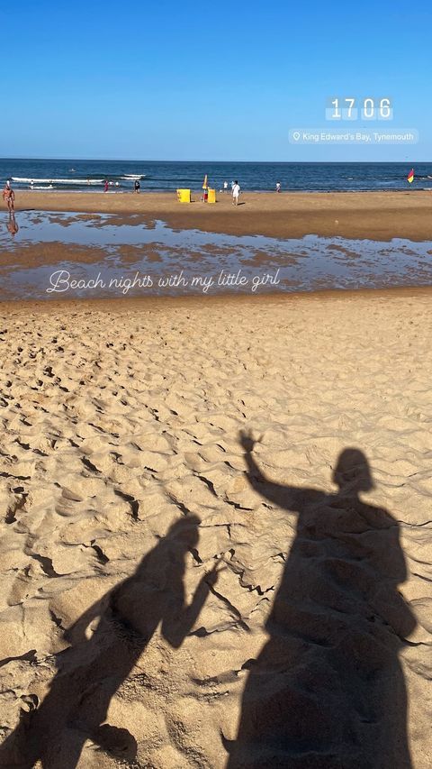 shadows of mother and daughter at beach