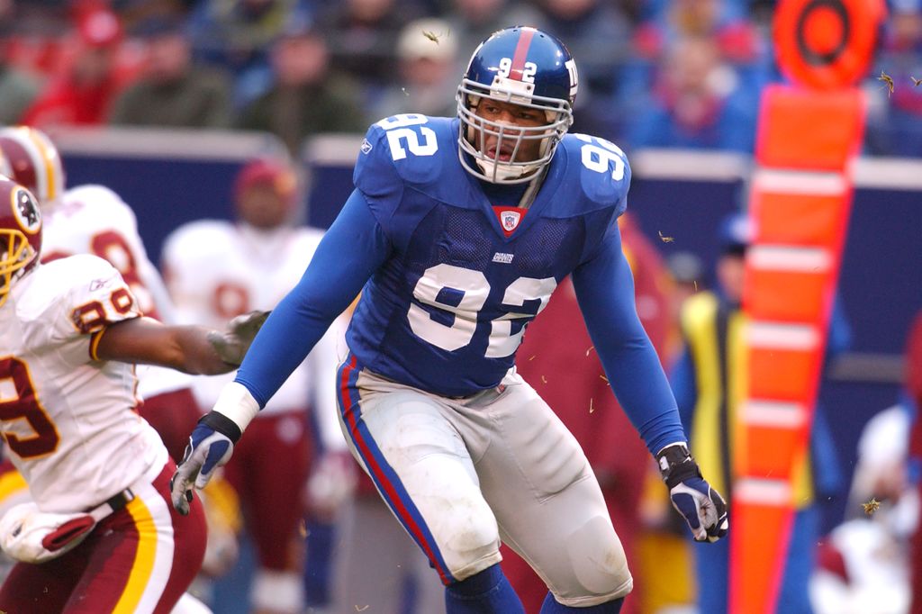 Michael Strahan #90 of the New York Giants in position during a NFL football game against the Washington Redskins on November 17, 2002 at Giants Stadium in East Rutherford, New Jersey