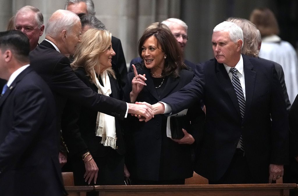 Joe Biden shakes hands with former Vice President Mike Pence as former first lady Jill Biden talks with former Vice President Kamala Harris at the funeral service of former Vice President Dick Cheney at the National Cathedral on November 20, 2025 in Washington, DC