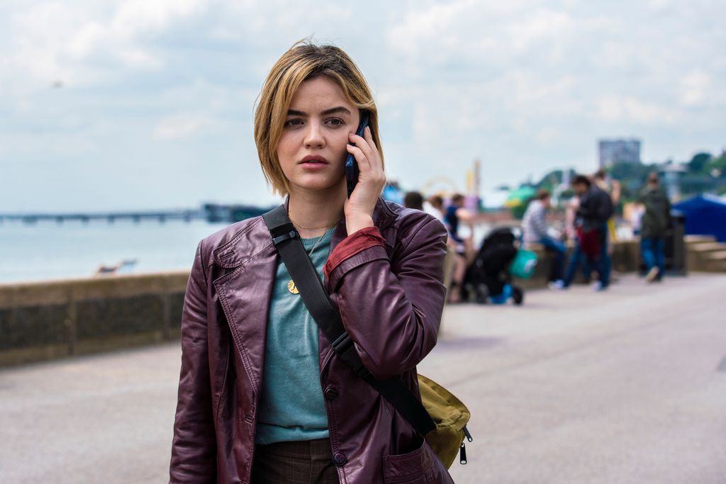 woman on phone standing on peer