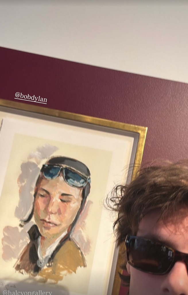A selfie showing Cruz Beckham wearing sunglasses standing in front of one of the artworks at the exhibition