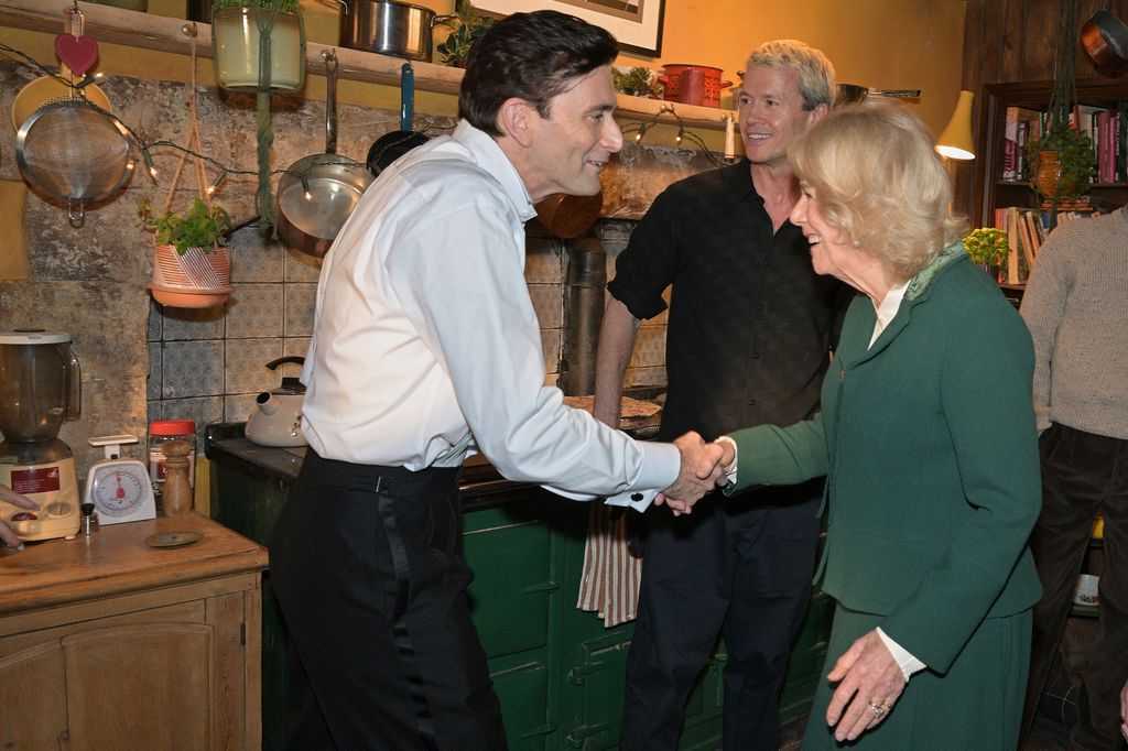 Queen Camilla shakes hands with actor David Tennant on set of Rivals