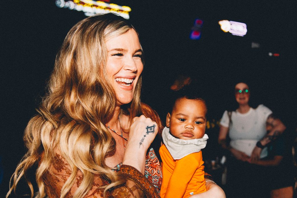 Josss Stone holding baby 