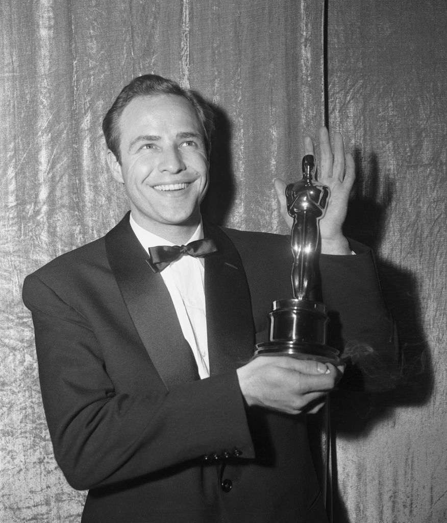 (Original Caption) Actor Marlon Brando is all smiles as he holds his Oscar which was awarded to him for the best actor of 1954. Brando, who won the Oscar for his performance in the film, On The Waterfront was overwhelmed by the honor Hollywood bestowed upon him.