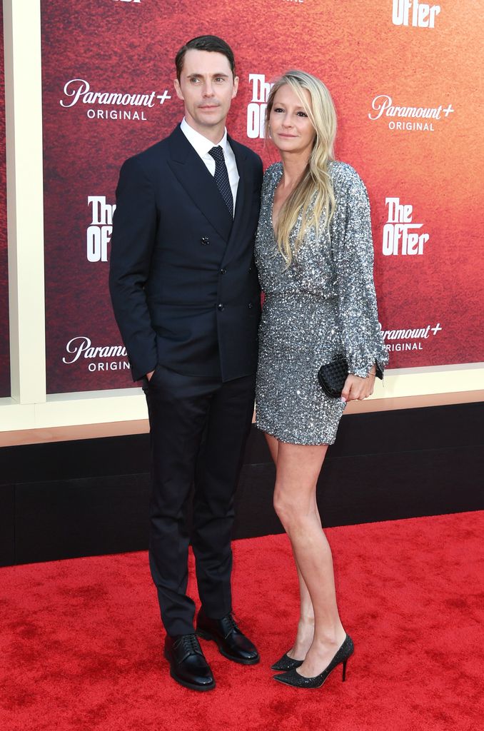 Matthew Goode and Sophie Dymoke on red carpet of premiere posing for photos
