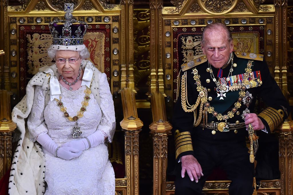The Queen and Prince Philip sat on golden thrones