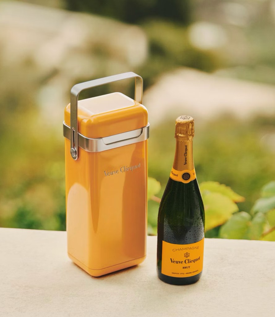 Veuve Clicquot Yellow Label Brut Champagne next to a yellow Cooler, 
