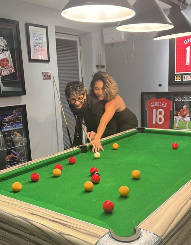 Karen Hauer and an elderly lady playing pool