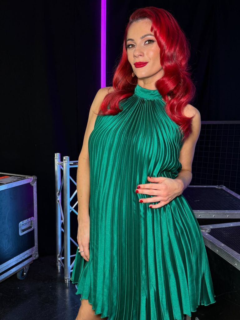 Dianne posed in emerald green dress with red hair