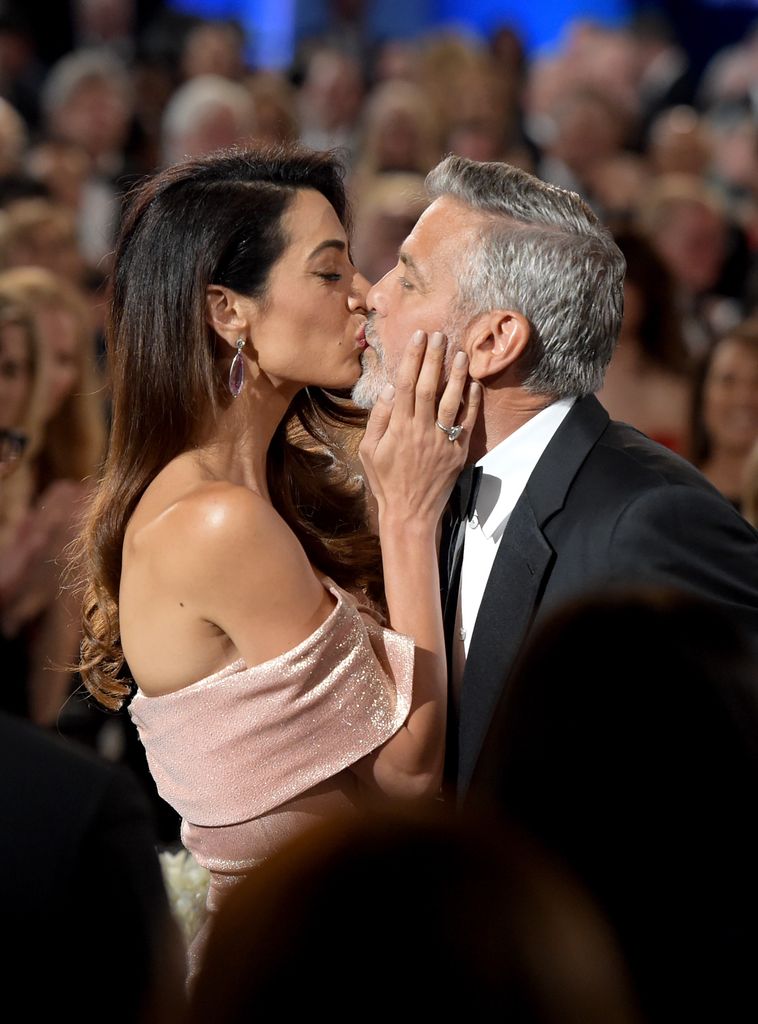 George and Amal kissing on red carpet