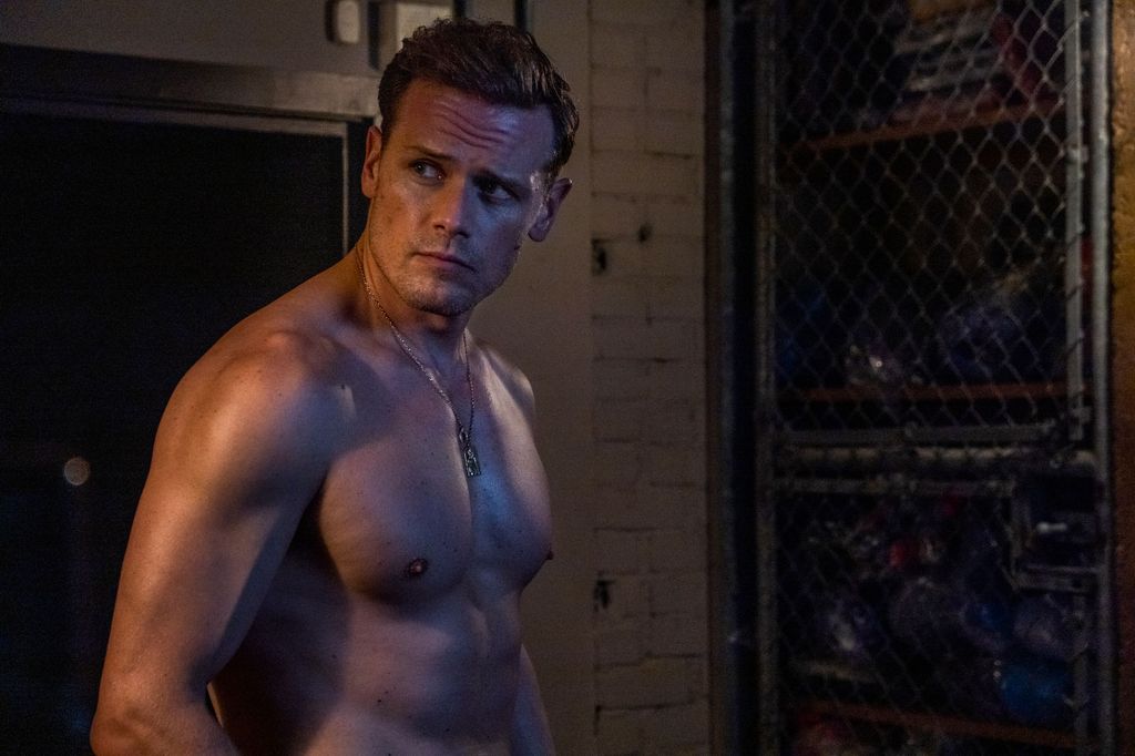 shirtless man in dimly-lit changing room 