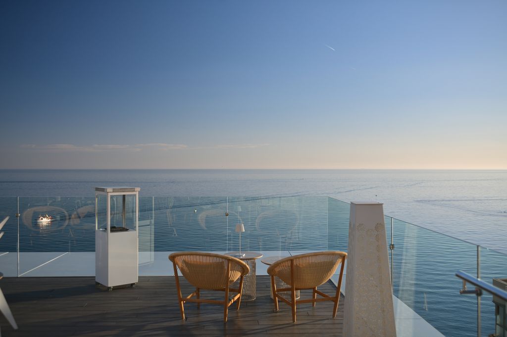 Two chairs overlooking Mediterranean Sea from rooftop bar