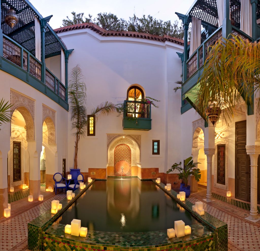 Le Farnatchi in Marrakech evening view of pool and main courtyard at boutique hotel