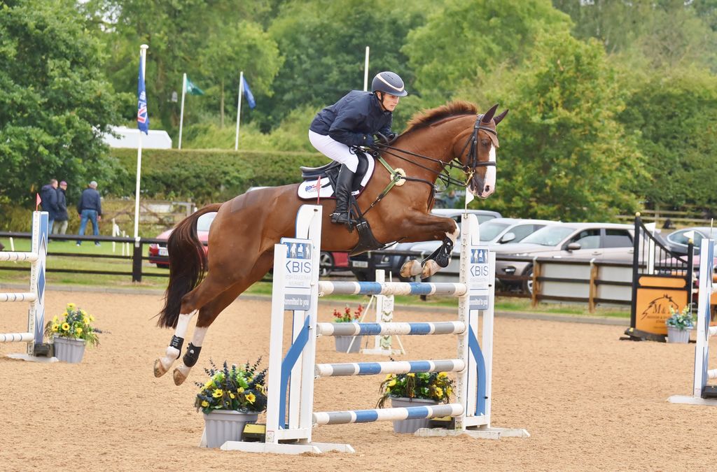 woman riding horse at eventing competition