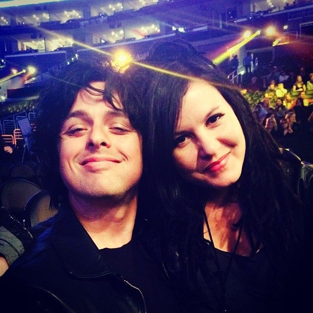 billie joe armstrong and wife adrienne smiling with heads together