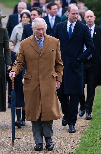 Prince William walking behind King Charles at Sandringham