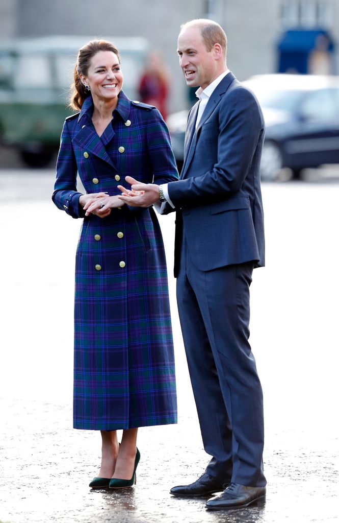 Kate in tartan coat smiling with William