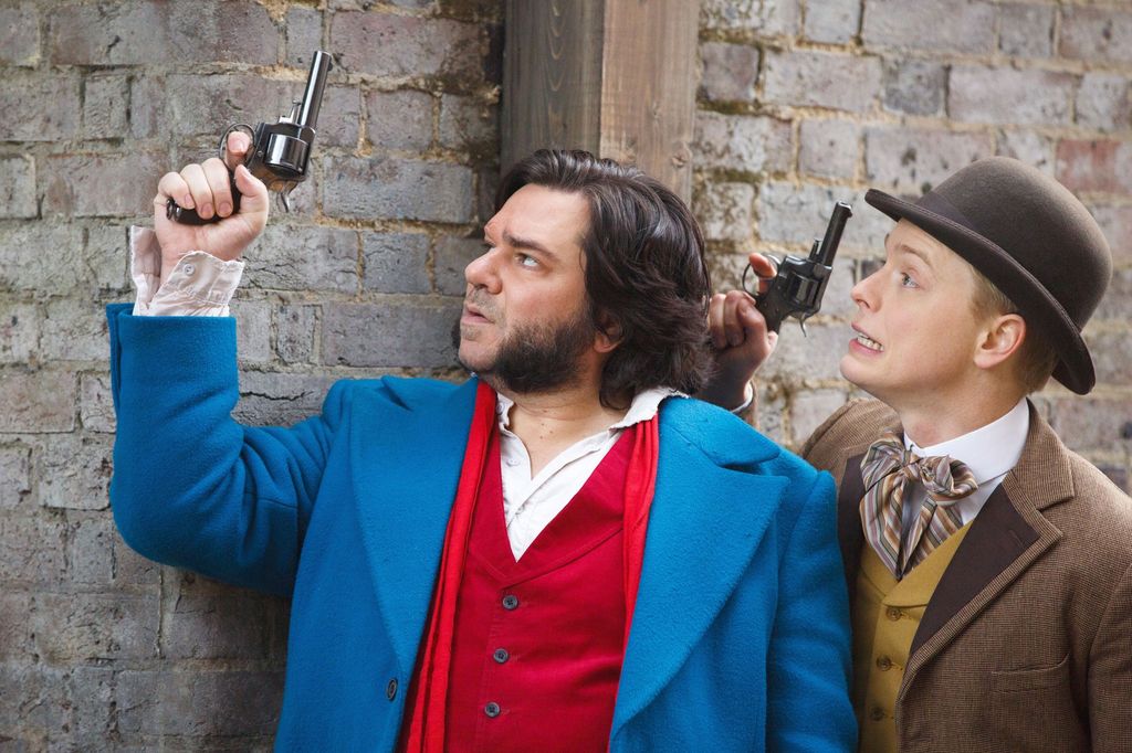 two men dressed in brightly coloured clothes holding guns
