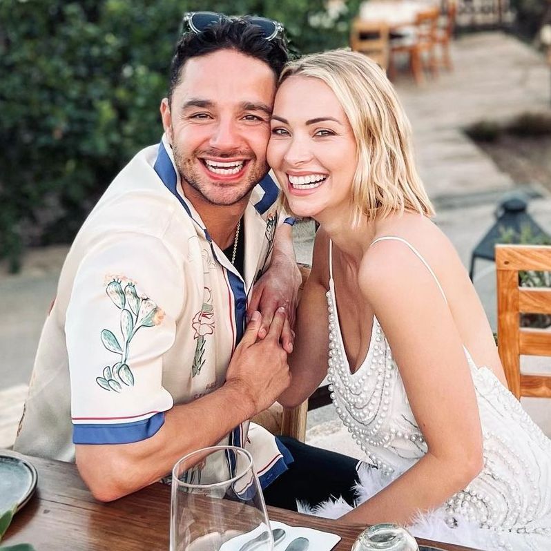 Adam Thomas and his wife Caroline sitting at table smiling for photo