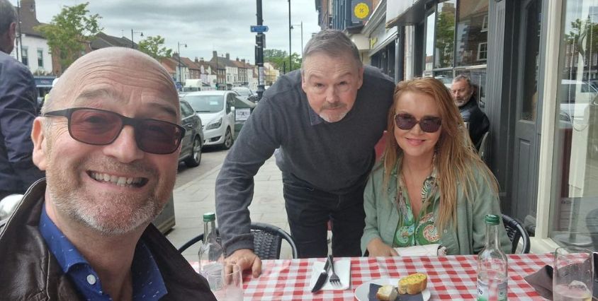 David Harper with siblings at an outdoor cafe