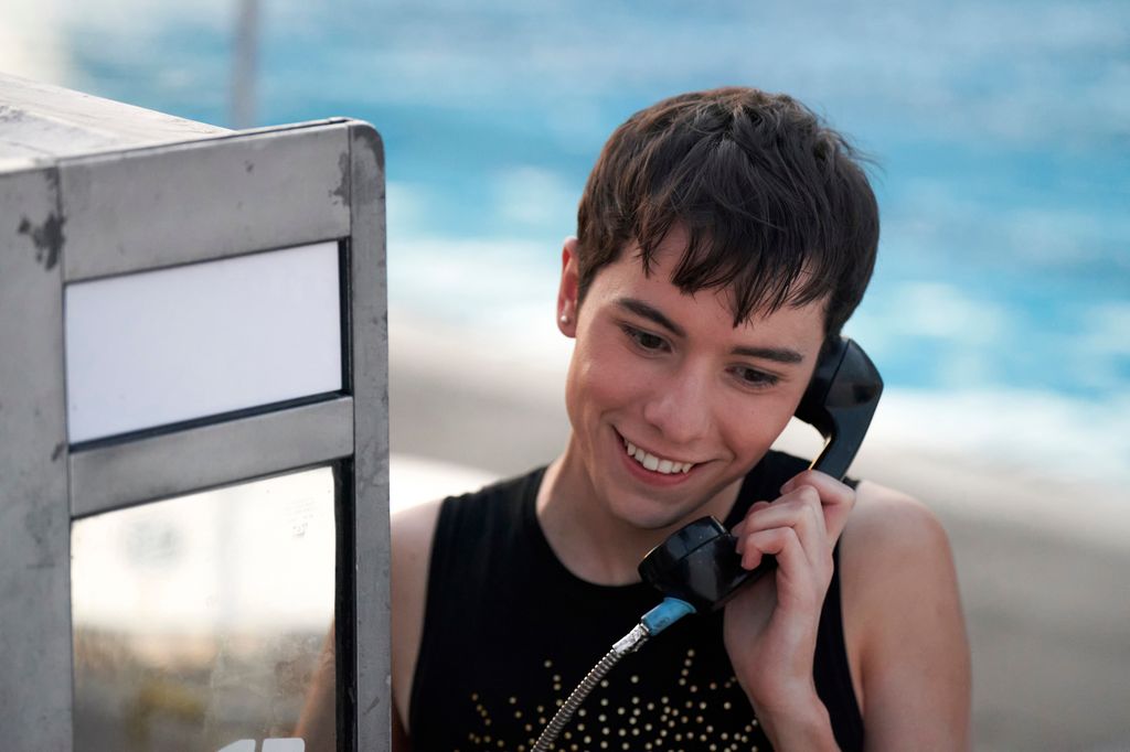 Woman talking on pay phone