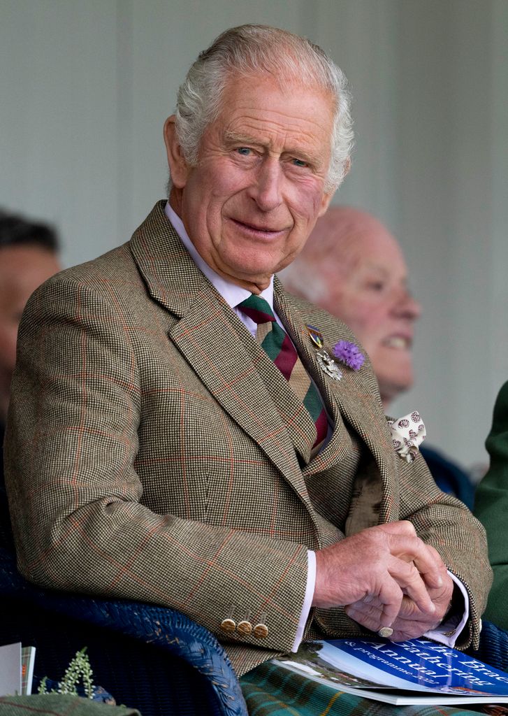 king charles smiling in tweed jacket at mey highland games