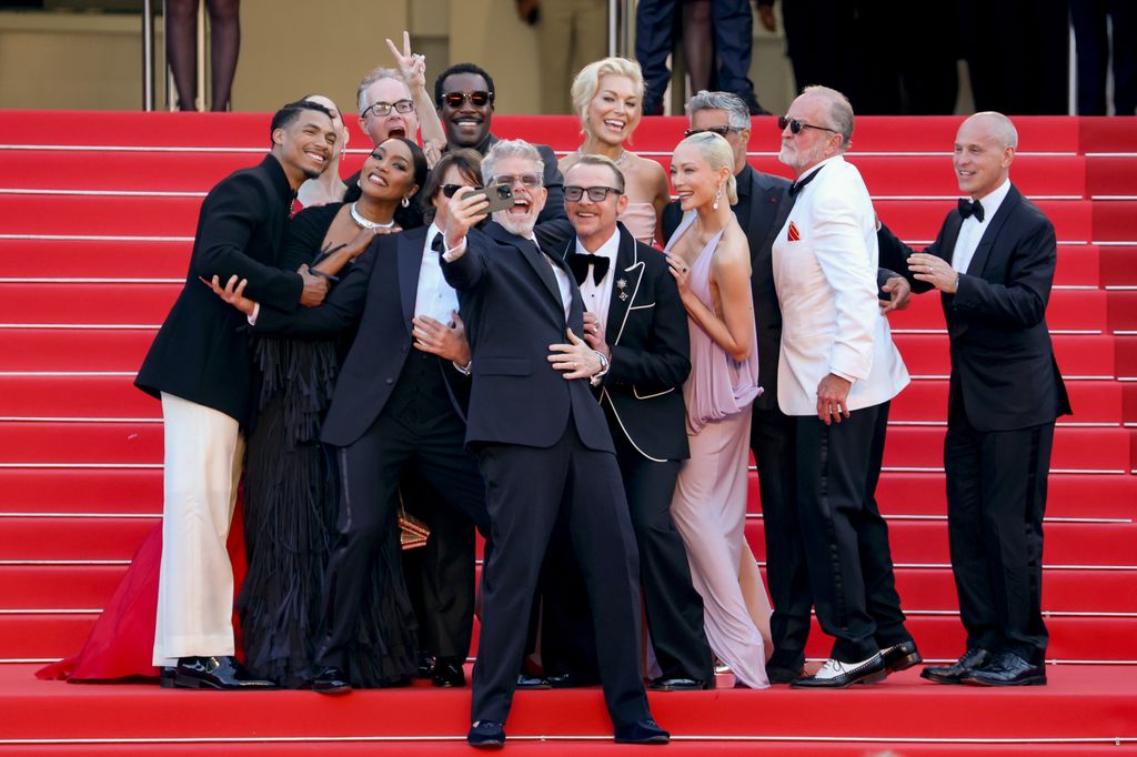 Greg Tarzan Davis, Hayley Atwell, Angela Bassett, Eddie Hamilton, Tom Cruise,Tramell Tillman, Christopher McQuarrie, Simon Pegg, Hannah Waddingham, Pom Klementieff, Esai Morales, Erik Jendresen and Brian Robbins take a selfie on the "Mission Impossible - The Final Reckoning" red carpet at the 78th annual Cannes Film Festival at Palais des Festivals on May 14, 2025 in Cannes, France