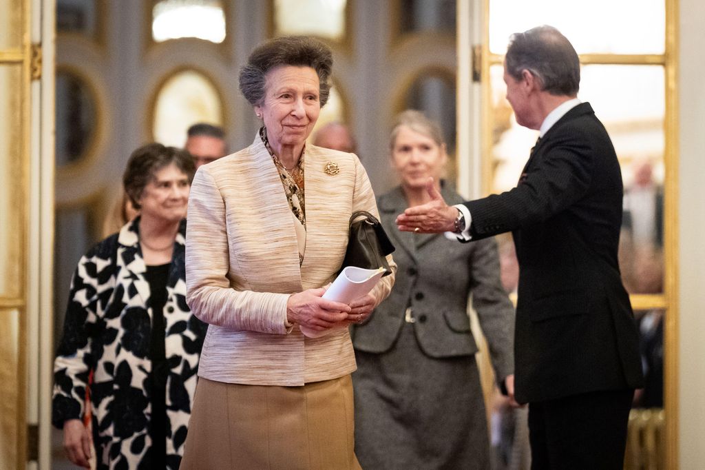 Princess Anne greeting a man while several women follow behind her