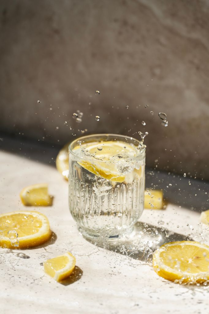 Glass of water with lemon and splash