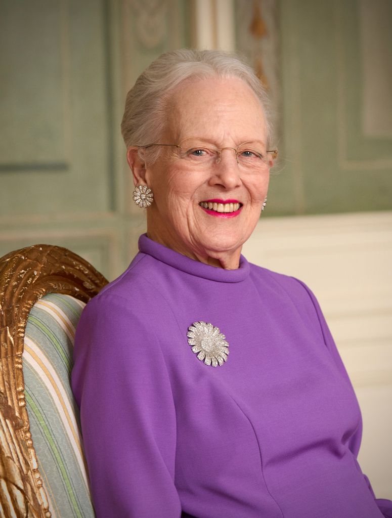 Queen Margrethe wearing purple dress, daisy brooch and earrings on 85th birthday