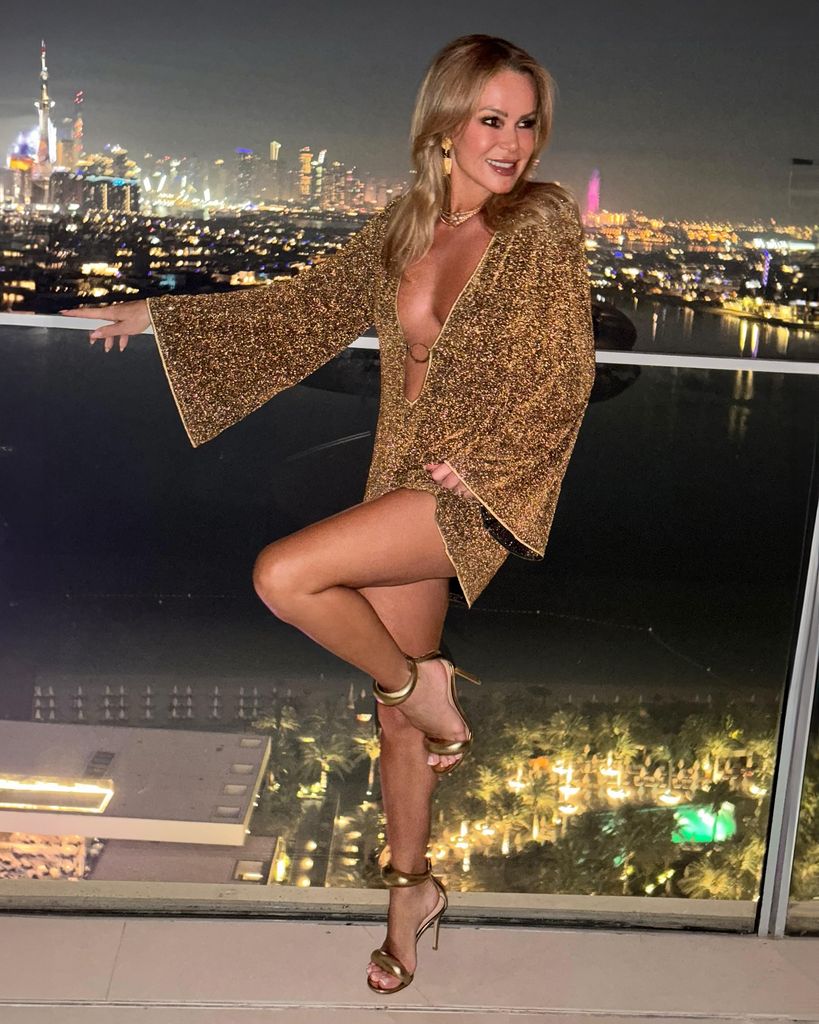 Amanda holden at night on balcony in gold dress