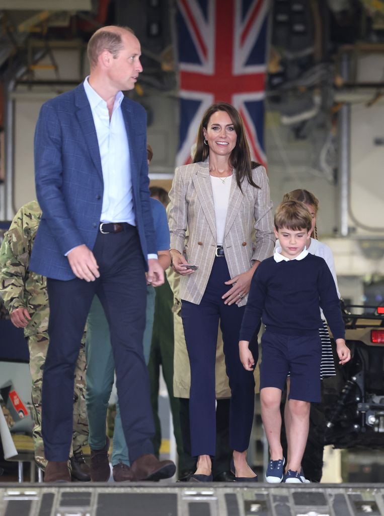 Kate Middleton wearing grey blazer white top and belted trousers at Air Tattoo